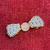 Handcrafted clear and gold glass bead bow charm made by a local artist