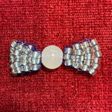 Handcrafted silver and blue glass bead bow charm made by a local artist